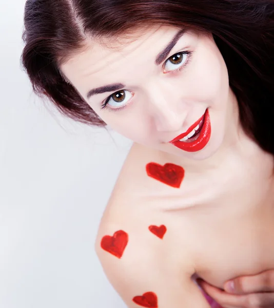 Brunette girl with red hearts — Stock Photo, Image