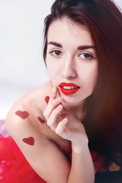 Brunette girl with red hearts — Stock Photo, Image