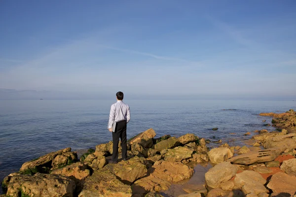 Man in de buurt van zee met laptop — Stockfoto