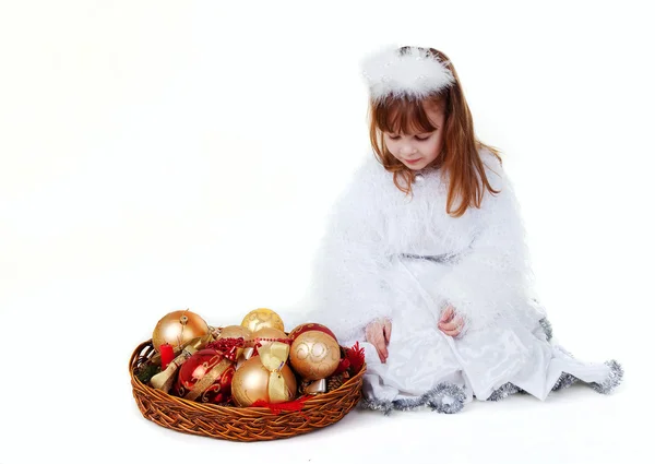 Little girl in christmas clothes with toy — Stock Photo, Image