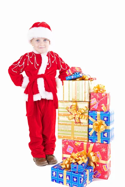 Boy in christmas clothes with presents — Stock Photo, Image
