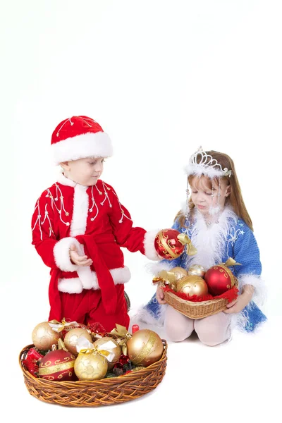 Little girl and boy in christmas clothes with toys — Stock Photo, Image