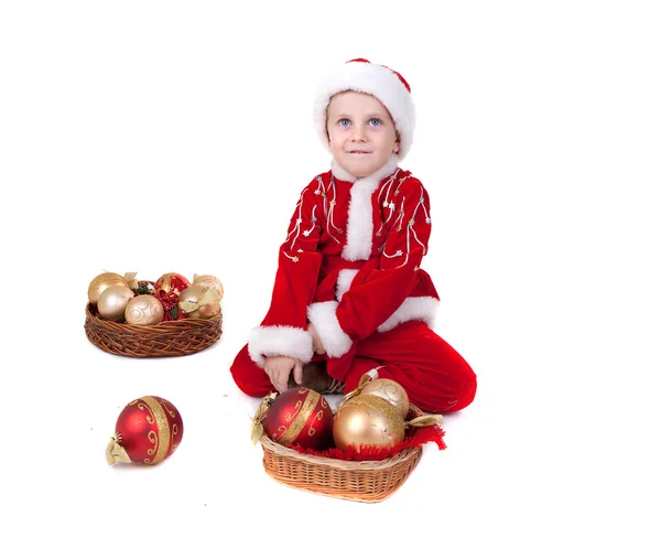 Boy in christmas clothes with toys — Stock Photo, Image
