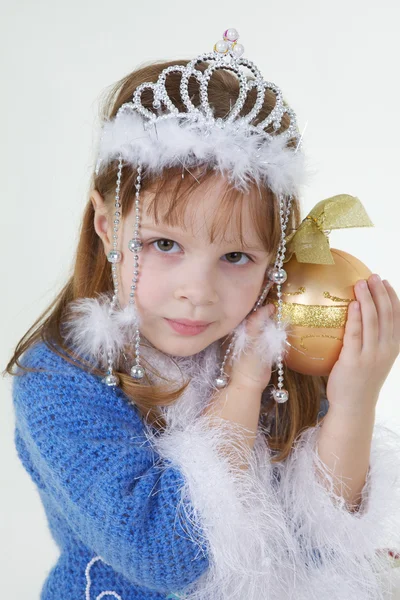 Little girl in christmas clothes with toy — Stock Photo, Image