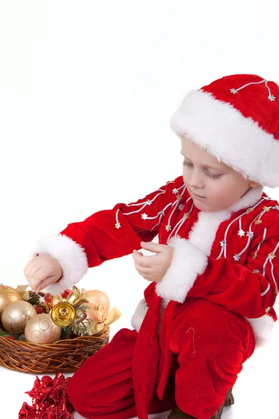 Menino em roupas de Natal com brinquedos — Fotografia de Stock
