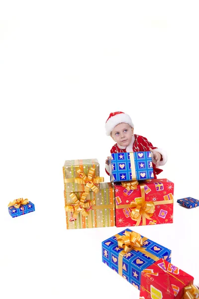 Boy in christmas clothes with presents — Stock Photo, Image