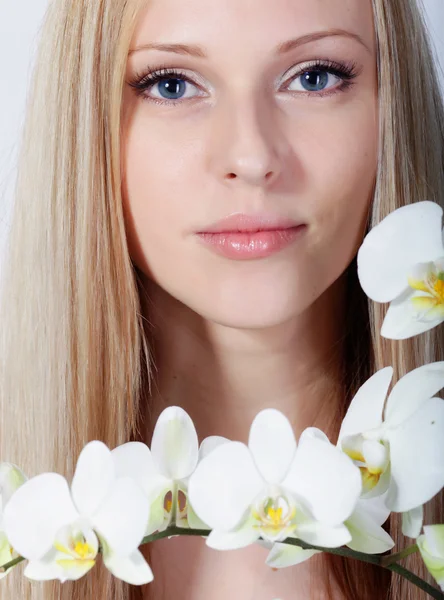 Girl with white orchid — Stock Photo, Image