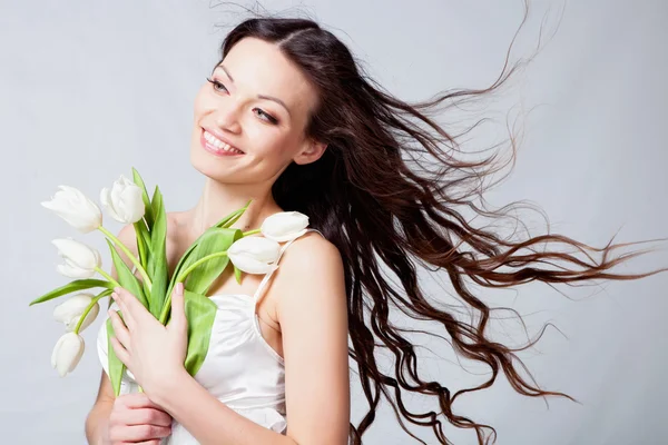 Beautiful brunette with orchid flowers — Stock Photo, Image