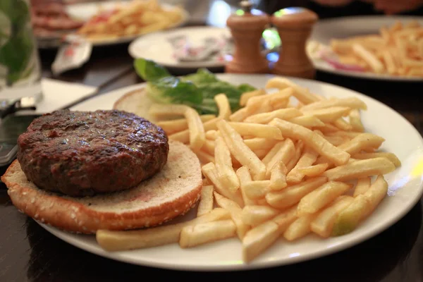 Hamburger and fried potatoes — Stock Photo, Image