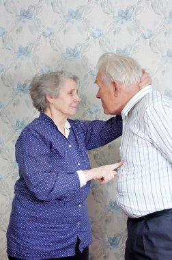 Senior couple jokingly discuss who is boss clipart