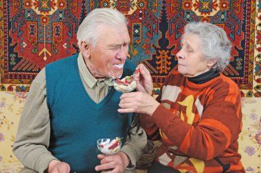 Old woman feed old man clipart