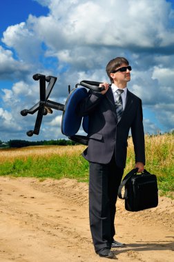 Young successful businessman takes his work to field clipart