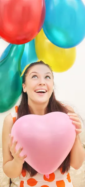 Girl looks admiringly at the balloons — Stock Photo, Image