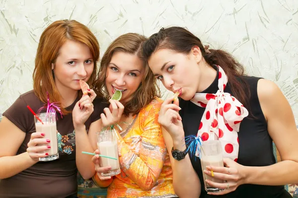 Three attractive girl eating fruit candies — Stock Photo, Image
