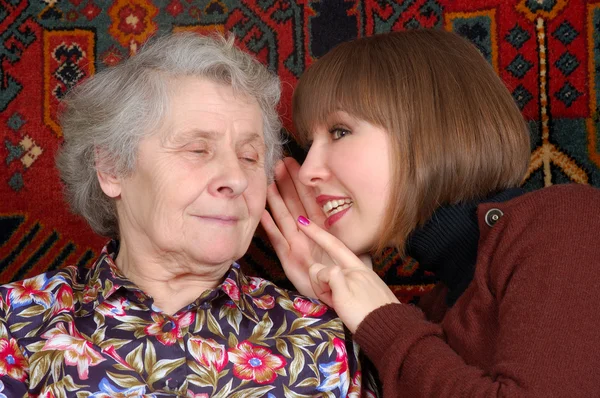 Grandmother and granddaughter gossiping — Stock Photo, Image