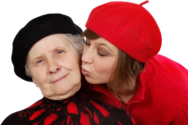 Granddaughter kiss grandmother cheek — Stock Photo, Image