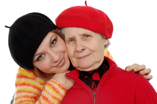 Happy grandmother and granddaughter with berets — Stock Photo, Image