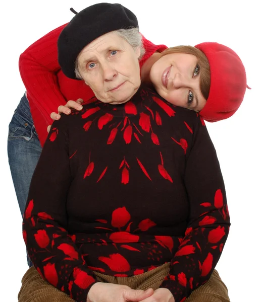 Happy grandmother and granddaughter with berets — Stock Photo, Image
