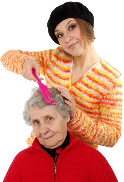 Grandchild brushes a grandmother — Stock Photo, Image