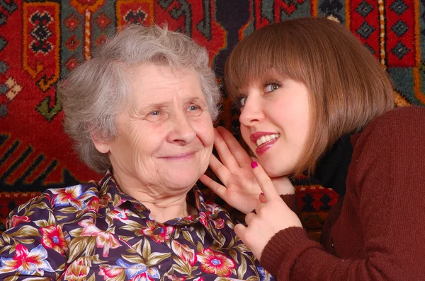 Grandmother and granddaughter gossiping — Stock Photo, Image