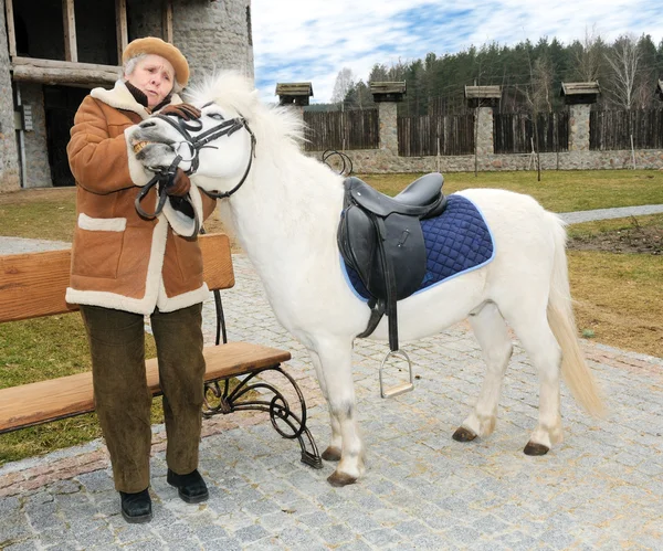Granny with pony outdoor — Stockfoto