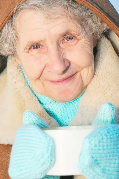 Ältere Frau mit Becher — Stockfoto