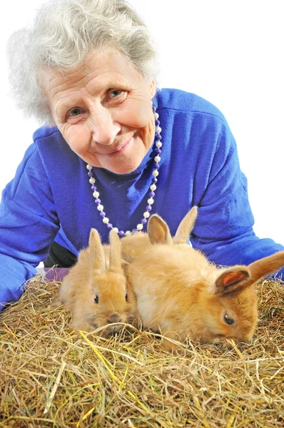 Elderly happy woman with rabbits — Stock Photo, Image