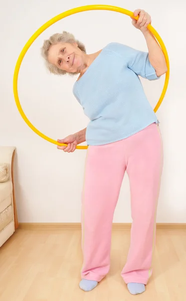 Granny doing gymnastic with hula-hoop — Stock Photo, Image