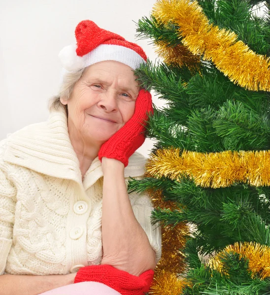 Granny in red Santa Claus hat and red mittens — Stock Photo, Image