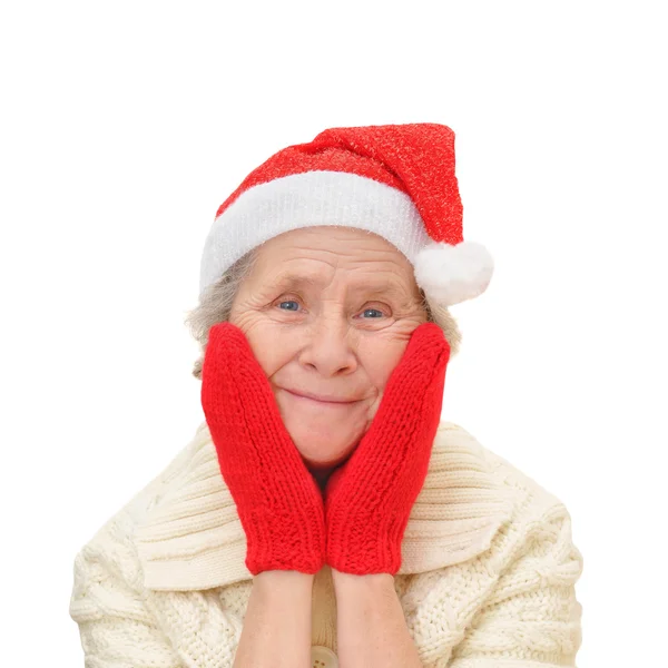 Stara kobieta w santa claus czerwony kapelusz i czerwone rękawice — Zdjęcie stockowe