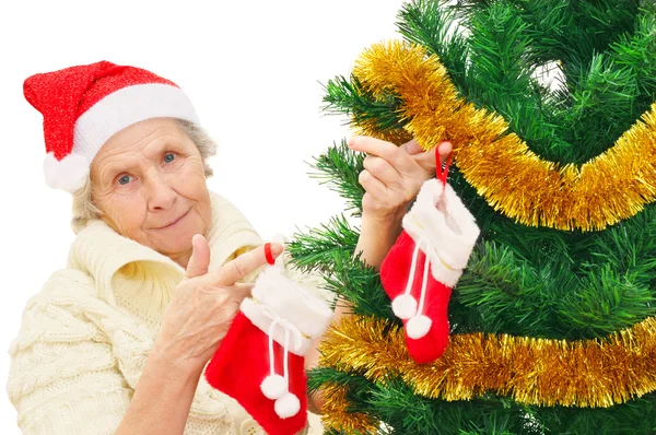 Granny in red Santa Claus hat and red socks — Stock Photo, Image