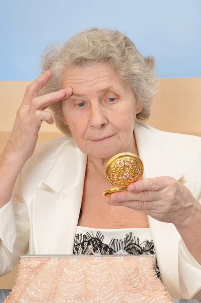 Senior lady with mirror — Stock Photo, Image