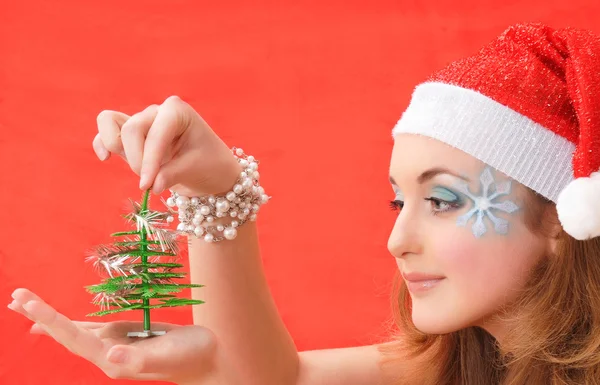 Snow Maiden look at Christmas tree — Stock Photo, Image