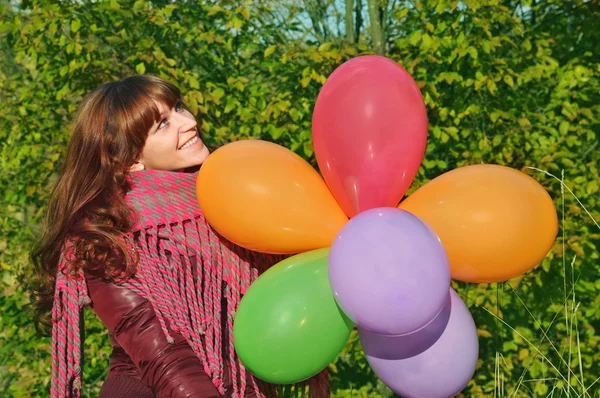 Girl with colorful balloons in park — Stock Photo, Image