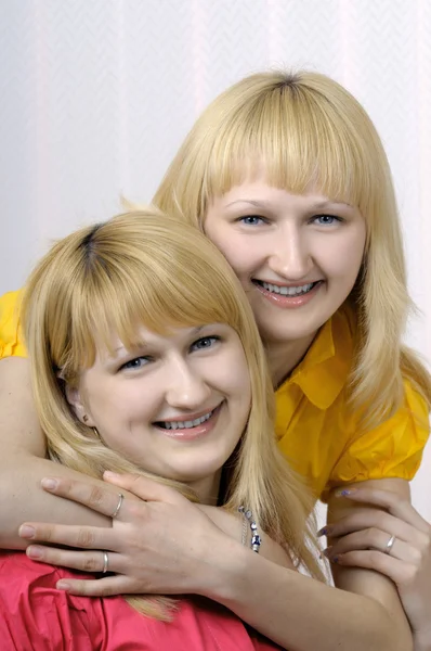 Portrait of two smiling blond sisters — Stock Photo, Image