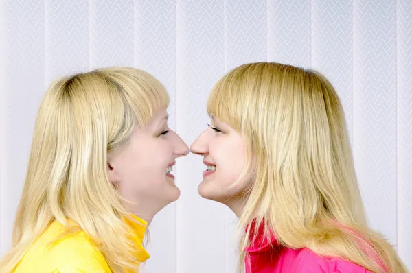Two beautiful blond girls nose to nose — Stock Photo, Image