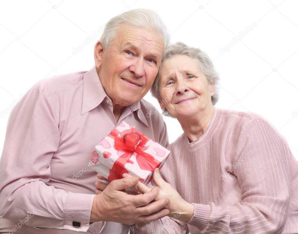 Happy old couple and box with gift