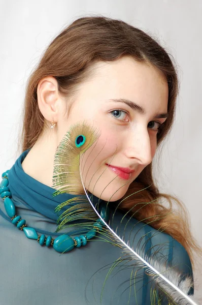 Girl with peacock feather — Stock Photo, Image