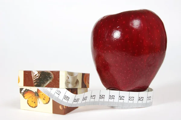 Red apple with box and tape-line — Stock Photo, Image