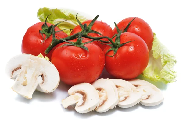 Tomatos with mushroom lie on leaves — Stock Photo, Image