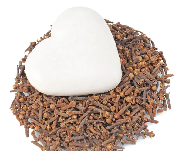 Spice-cake on pile cloves — Stock Photo, Image