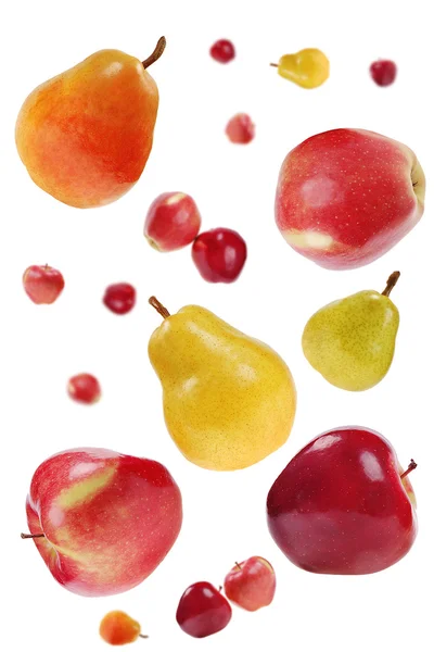 Flying red apples and colorful pears — Stock Photo, Image