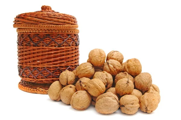 Heap of nuts and basket — Stock Photo, Image