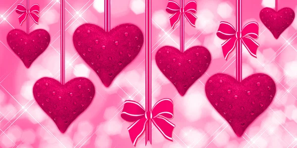 Pink hearts hanging with bows — Stock Photo, Image