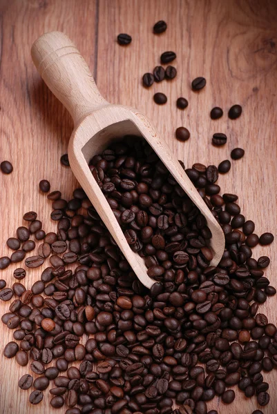 Coffee beans with a wooden spoon — Stock Photo, Image