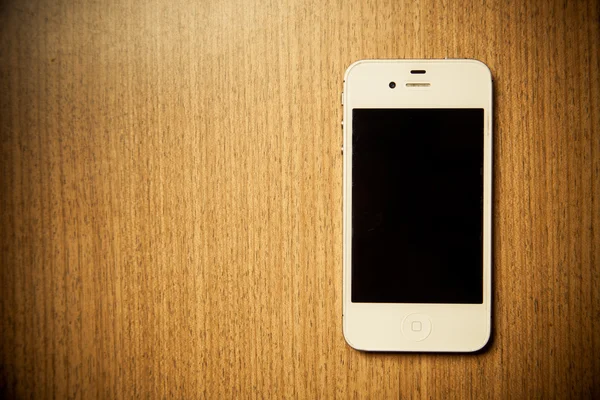 Apple iPhone 4s na mesa de madeira Imagens De Bancos De Imagens