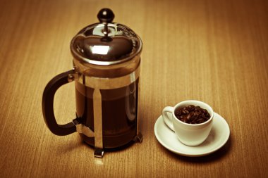 White coffee mug on white plate with french press clipart