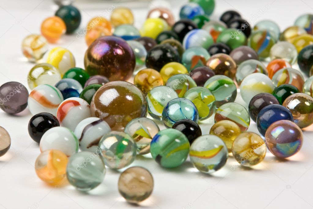 Wave of spilled colorful glass marbles