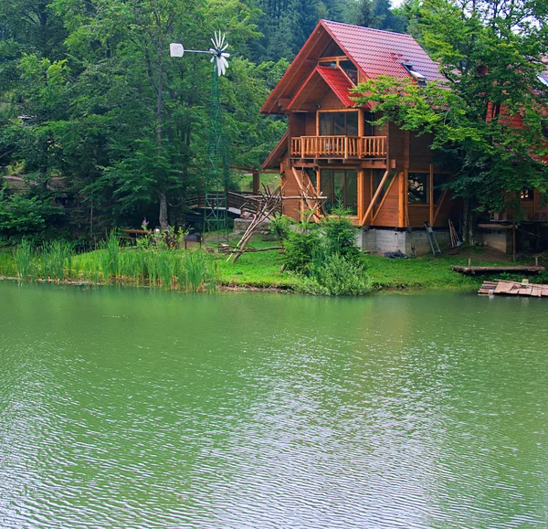 stock image Lake with the wooden house ashore in the summer