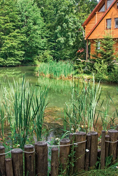 stock image Beautiful wooden house on lake